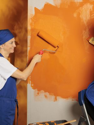 small-family-using-orange-paint-walls-young-child-ladder-painting-surface-with-paintbrush-mother-using-roller-brush-tool-people-having-fun-with-housework-renovation-home-decor